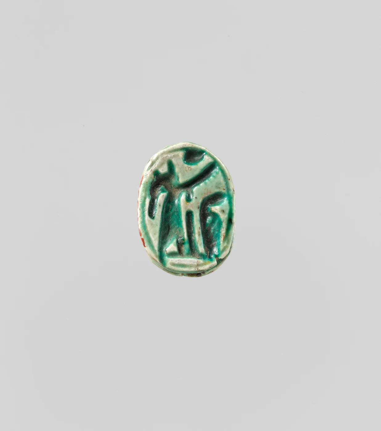 Scarab with Figure of Winged Seth-Baal; green glazed steatite.