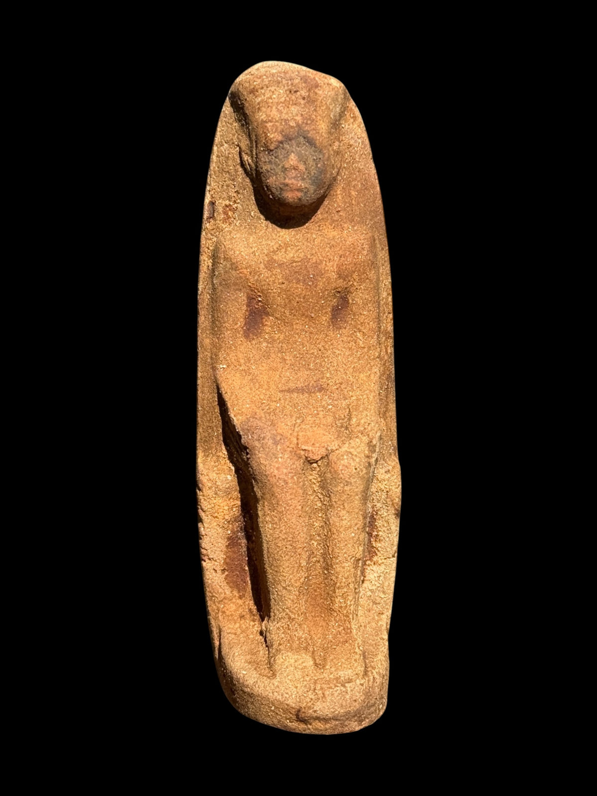 Front view of the King Taharqa ushabti with ochre tones and a broad headdress, 8 cm tall, item SHB-007.