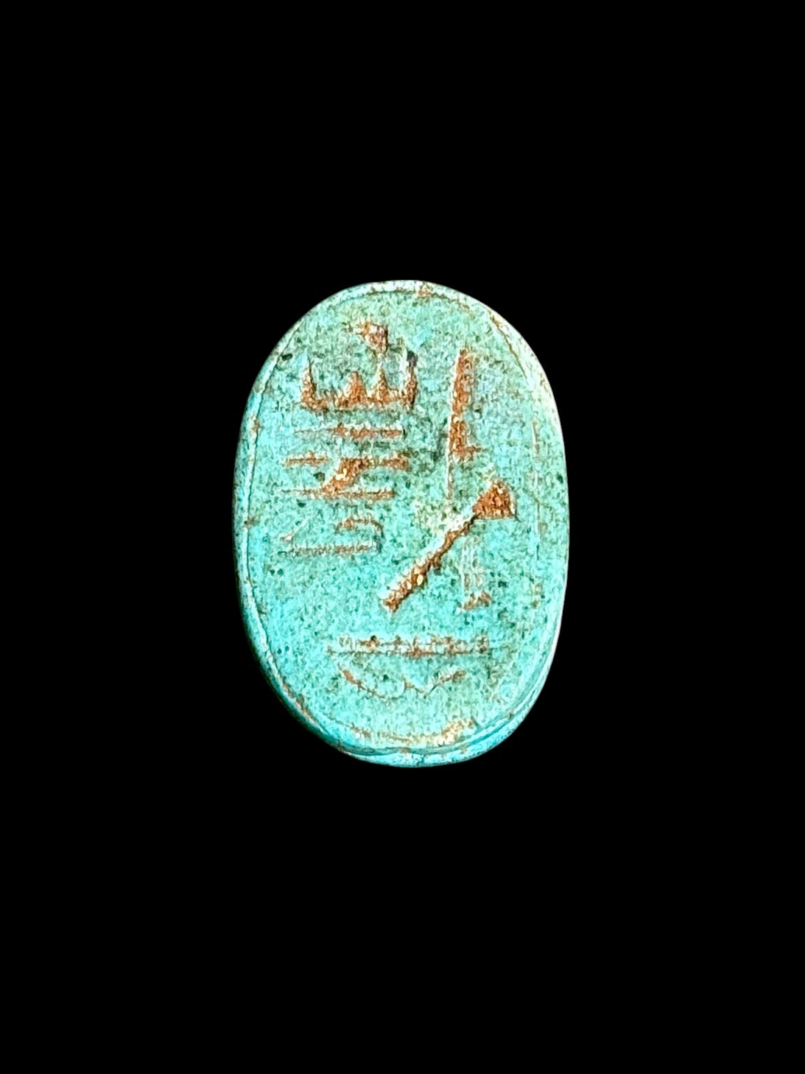 Underside of Egyptian scarab SC-109, showing turquoise underside with warm brown incised markings.