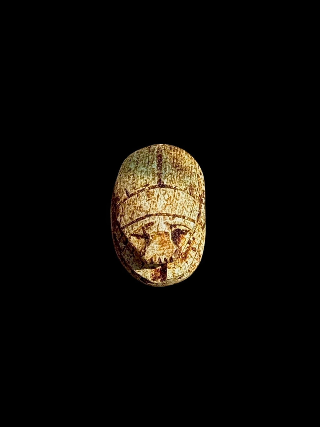 Top view of Egyptian scarab SC-049, showing mottled cream and golden-brown tones.