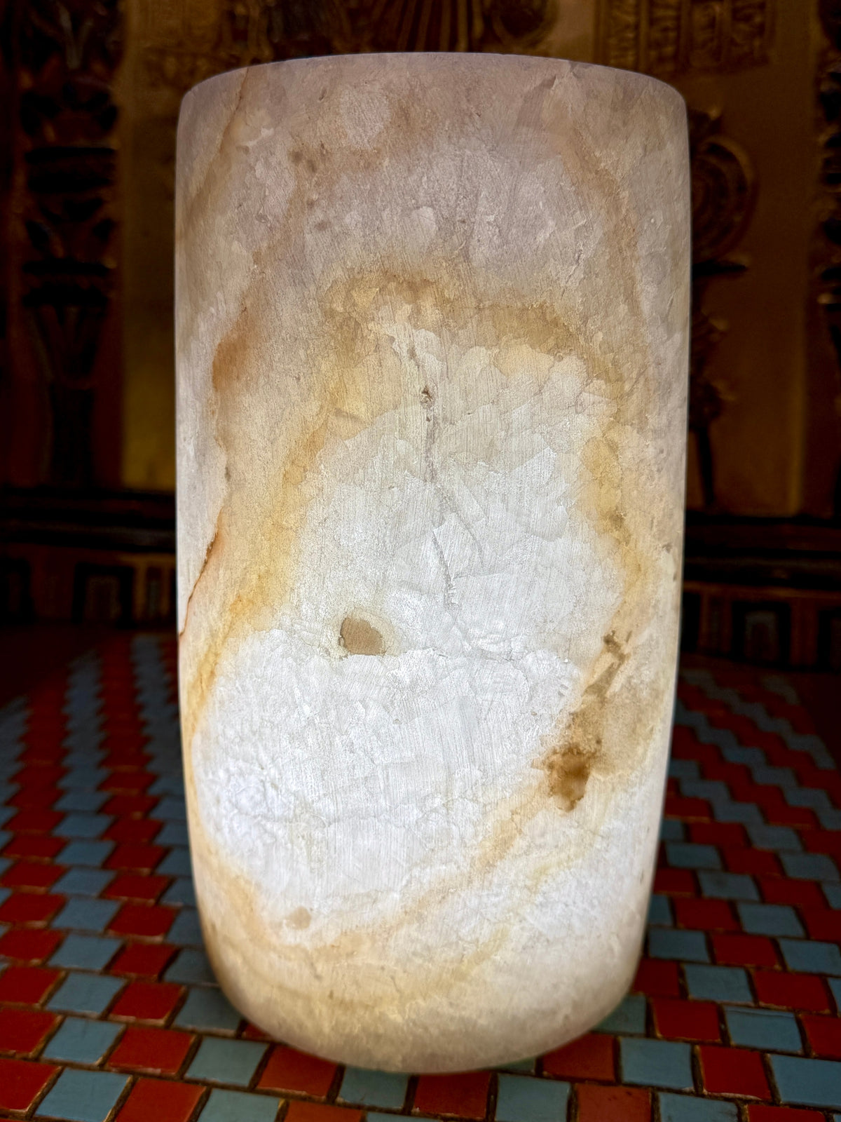 Slender cream alabaster cylinder vase with a rounded base and sweeping honey-coloured vein — additional view 1.