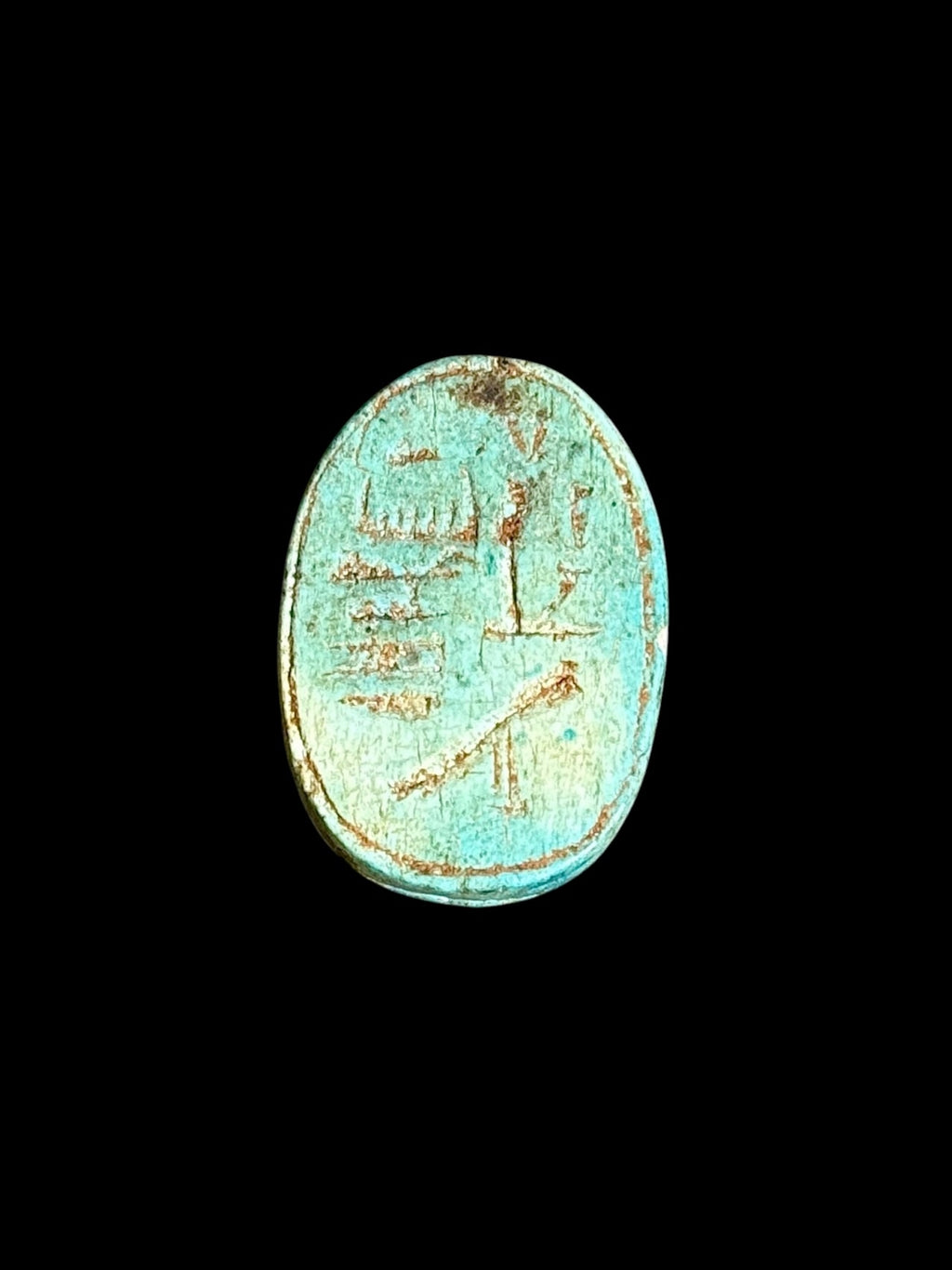 Underside of Egyptian scarab SC-107, showing blue-green underside with contrasting incised markings.