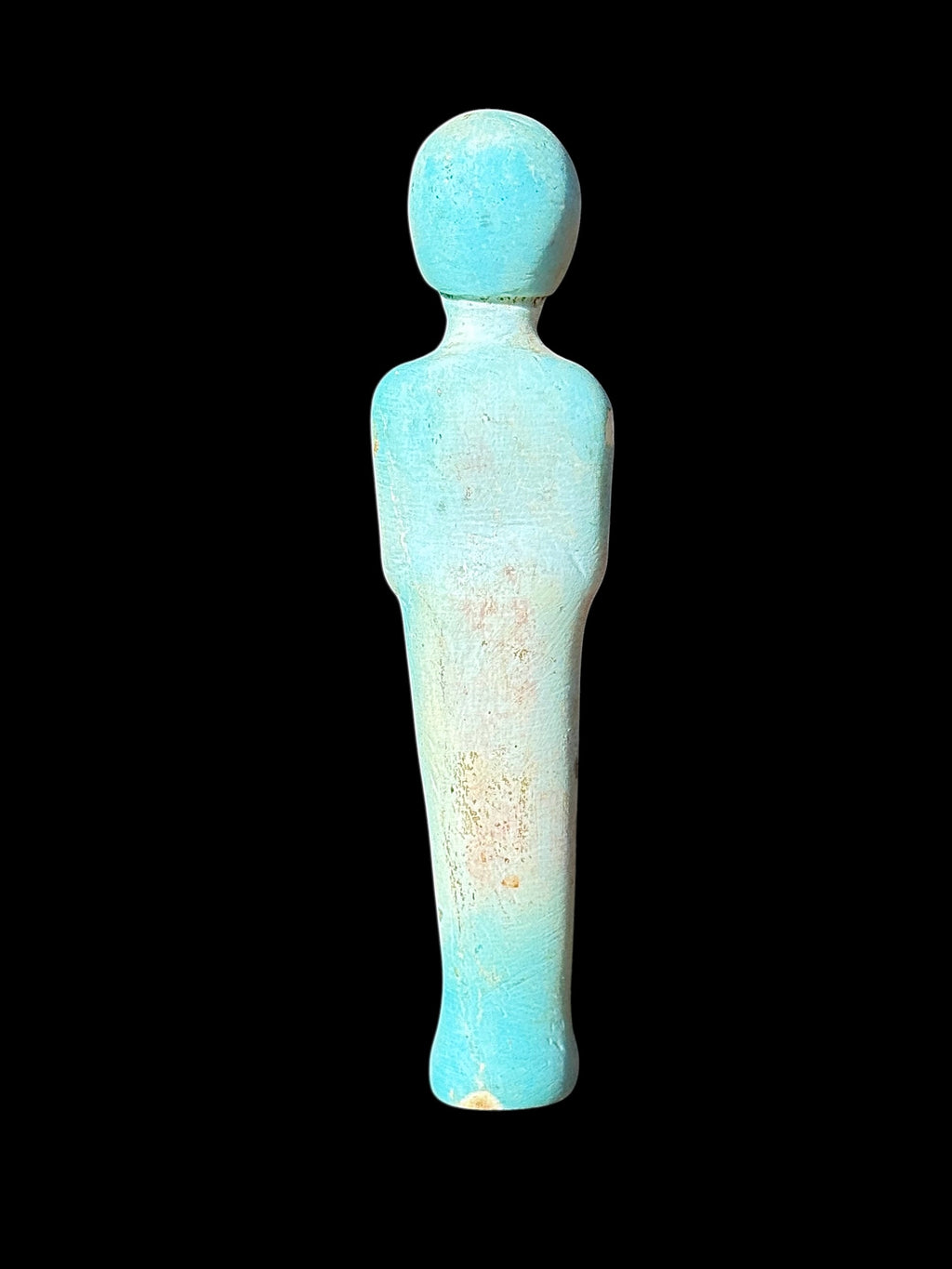 Back view of the shabti figurine showing a rounded head, plain slender body and turquoise colouring with pale cream and tan patches.