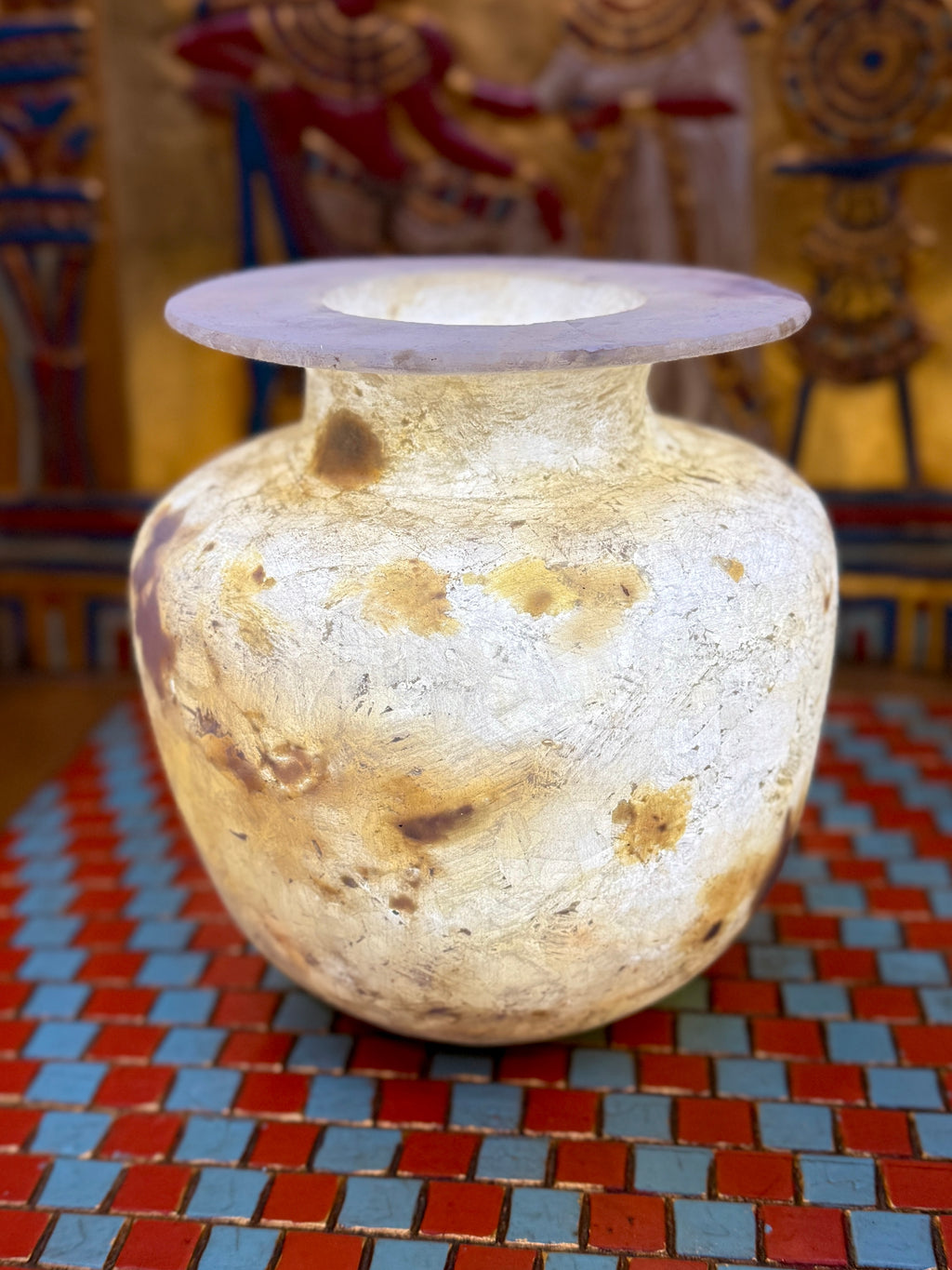 Rounded alabaster vase with cloudy cream stone, honey and brown patches, a low neck and broad flared rim — full view.