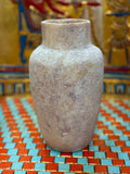 Slender smoky taupe and cream alabaster vase with rounded shoulders and a straight neck — unlit full view.
