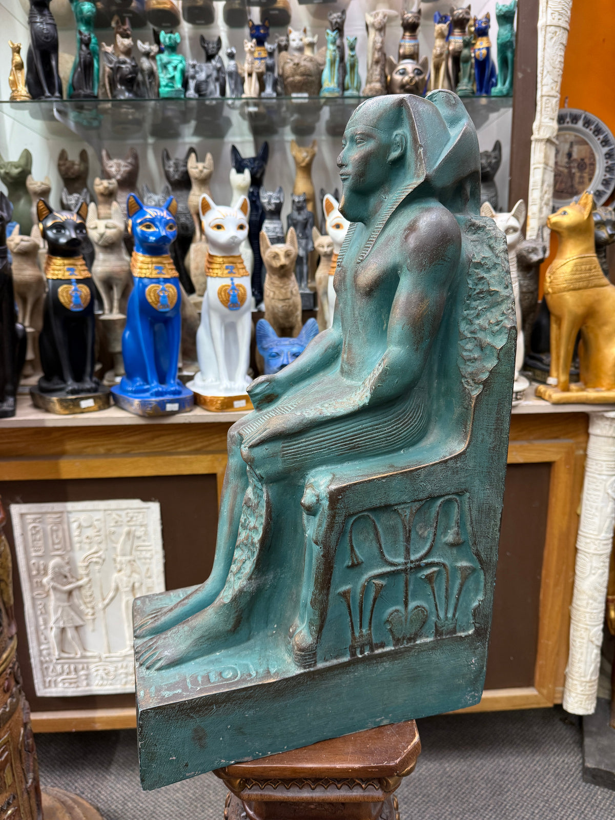 Side view of the Khafre statue, showing the seated pose and the unification motif on the side of the throne.