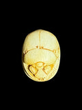Top view of Egyptian scarab SC-120, showing warm cream and golden tones.