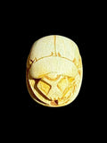 Top view of Egyptian scarab SC-098, showing cream and pale green tones with golden accents.