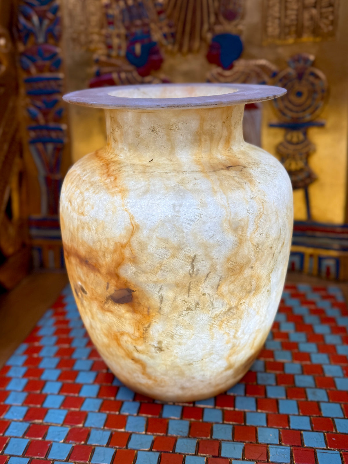 Broad cream alabaster vase with caramel-coloured swirls, rounded shoulders and a wide flared rim — full view.