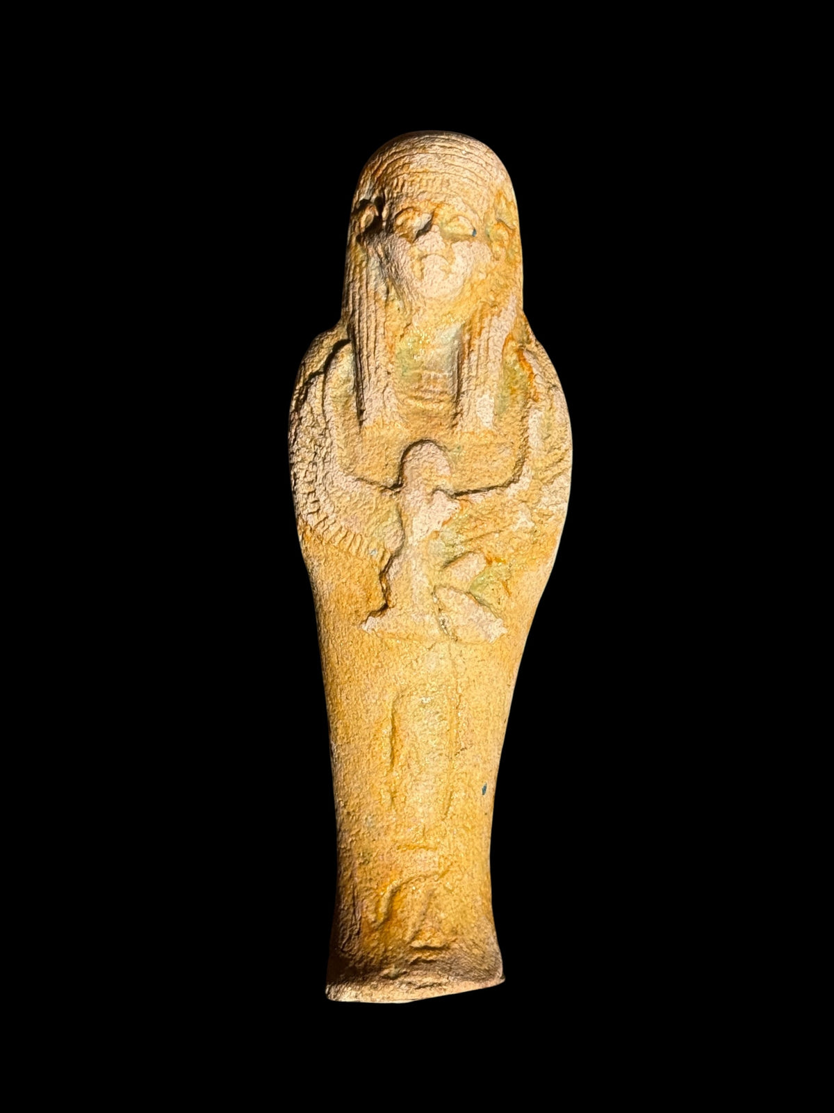 Front view of a sandy yellow and cream Egyptian stone figurine with a long headdress and winged Isis depicted across the front.