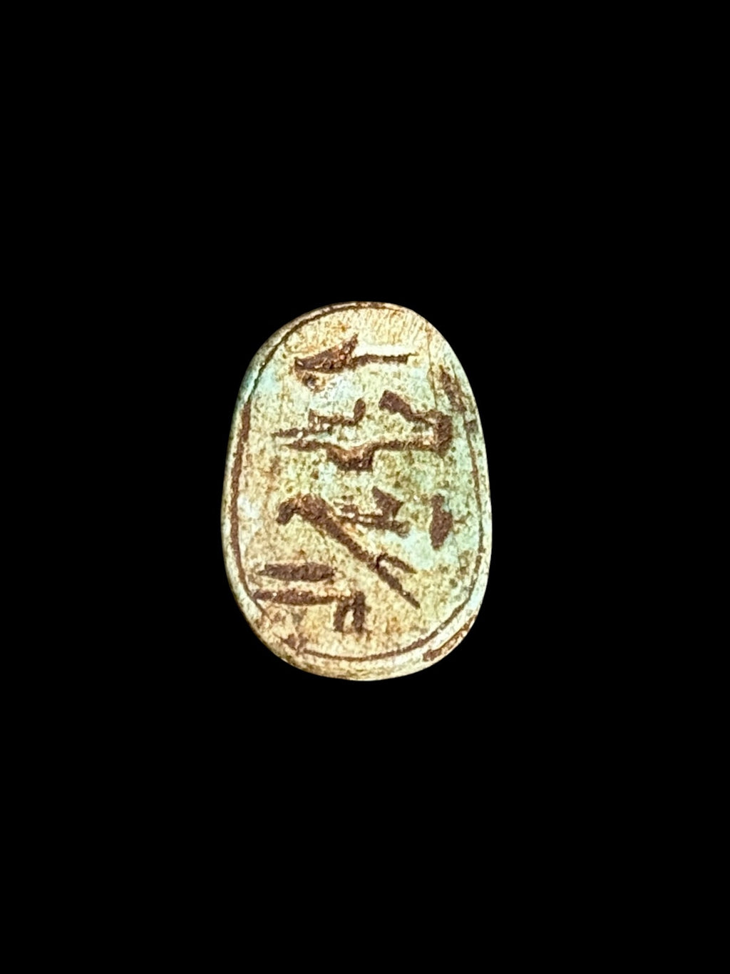 Underside of Egyptian scarab SC-112, showing cream underside with darker incised markings.