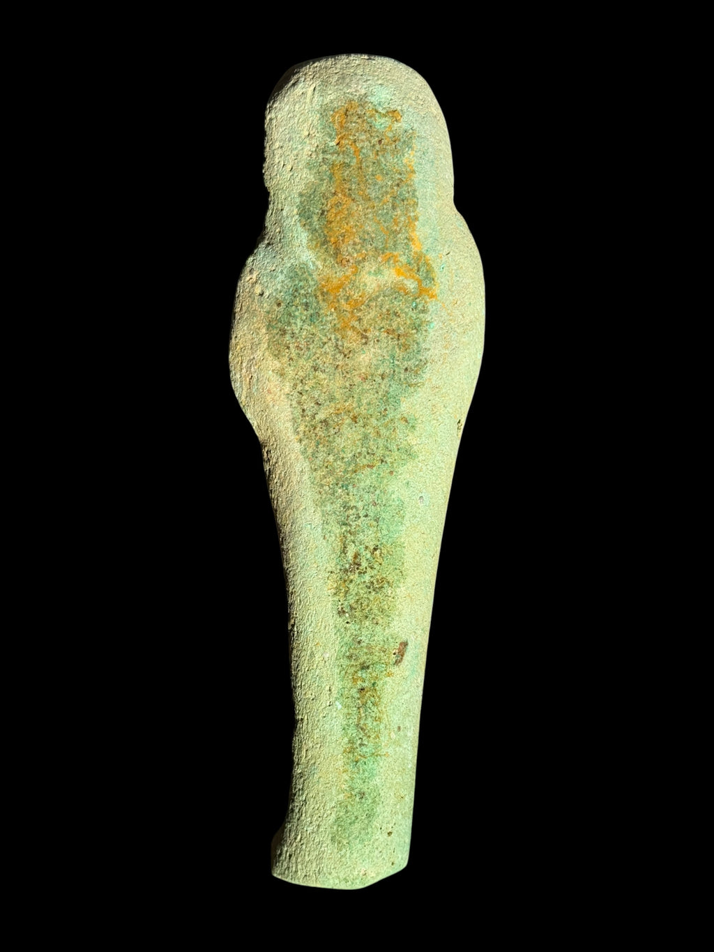 Rear view of the shabti showing its rounded head, shoulders and tapered body, with a textured pale green surface and yellow-brown mottling.