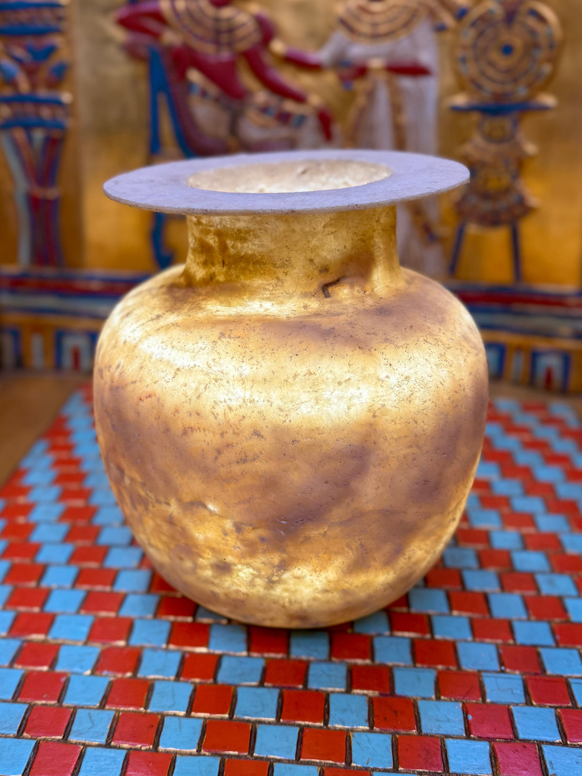 Rounded alabaster vase with smoky brown and honey-coloured layers, a short neck and flared rim — full view.