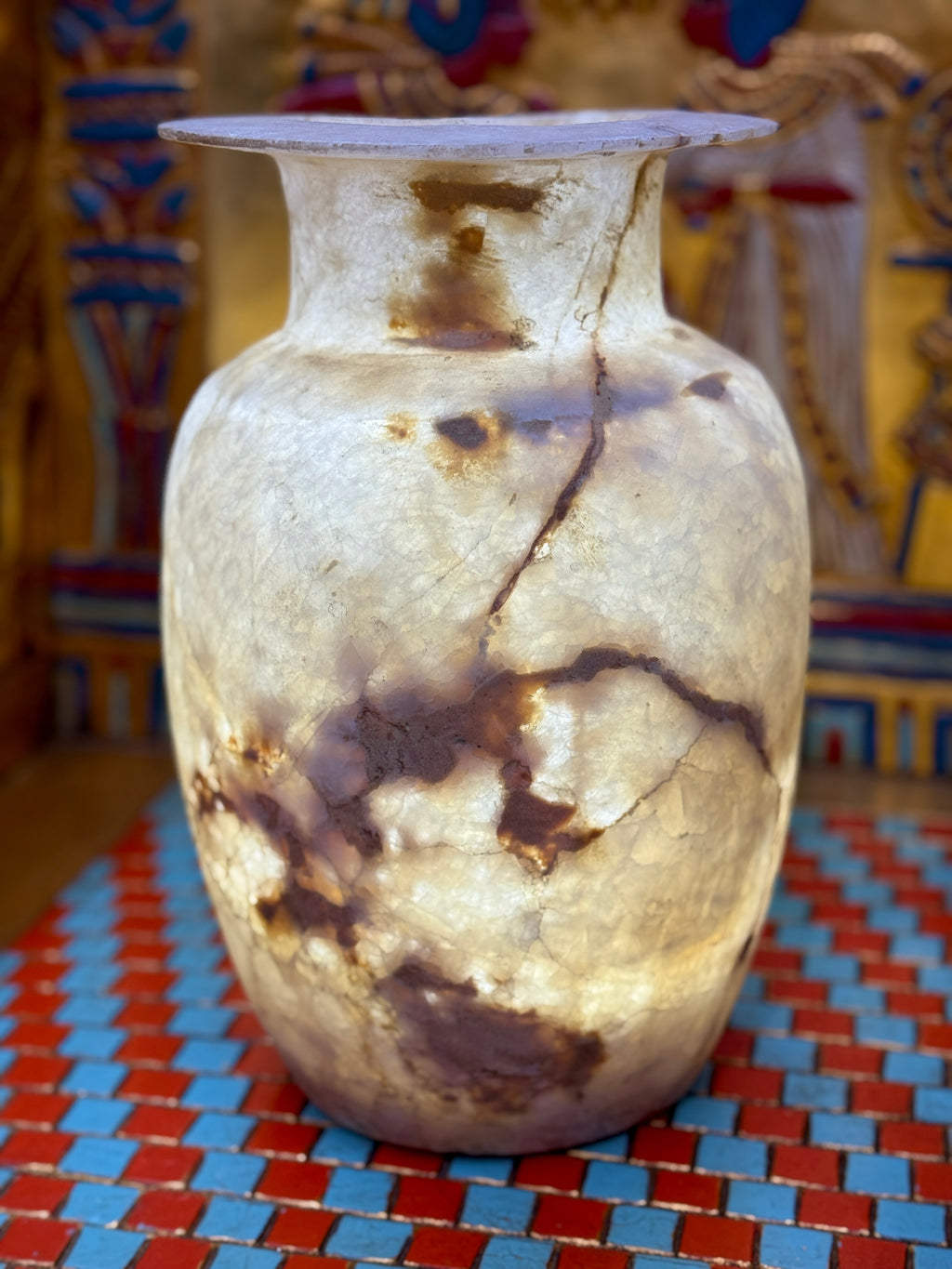 Tall pale alabaster vase with branching brown veins, an upright neck and flared rim — additional view 2.