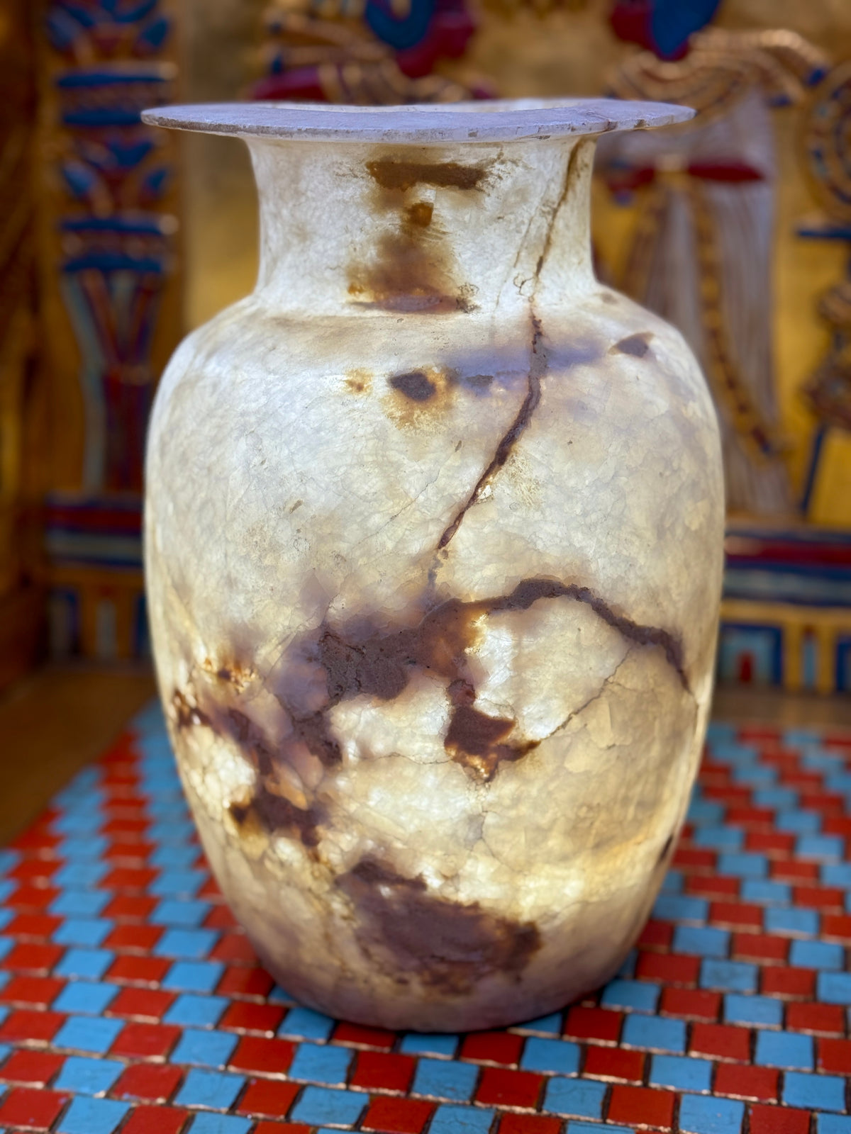 Tall pale alabaster vase with branching brown veins, an upright neck and flared rim — additional view 2.