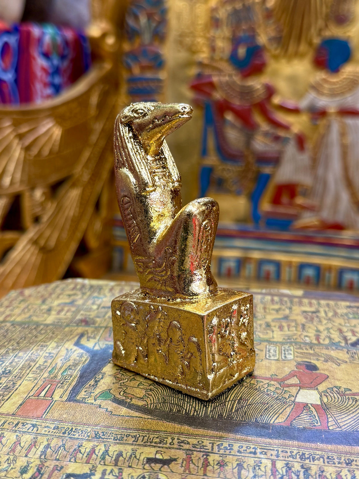 Front angled view of the gold finish Sobek kneeling statue with crocodile head and decorated square base.
