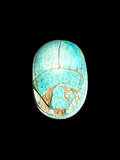 Top view of Egyptian scarab SC-100, showing bright turquoise tones with brown accents in the carved details.