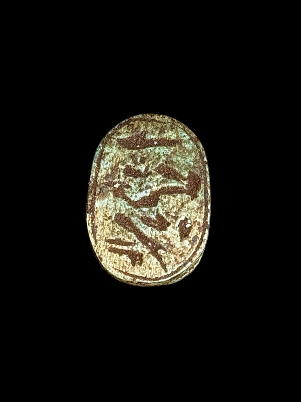 Underside of Egyptian scarab SC-113, showing pale underside with bold, dark incised motifs.