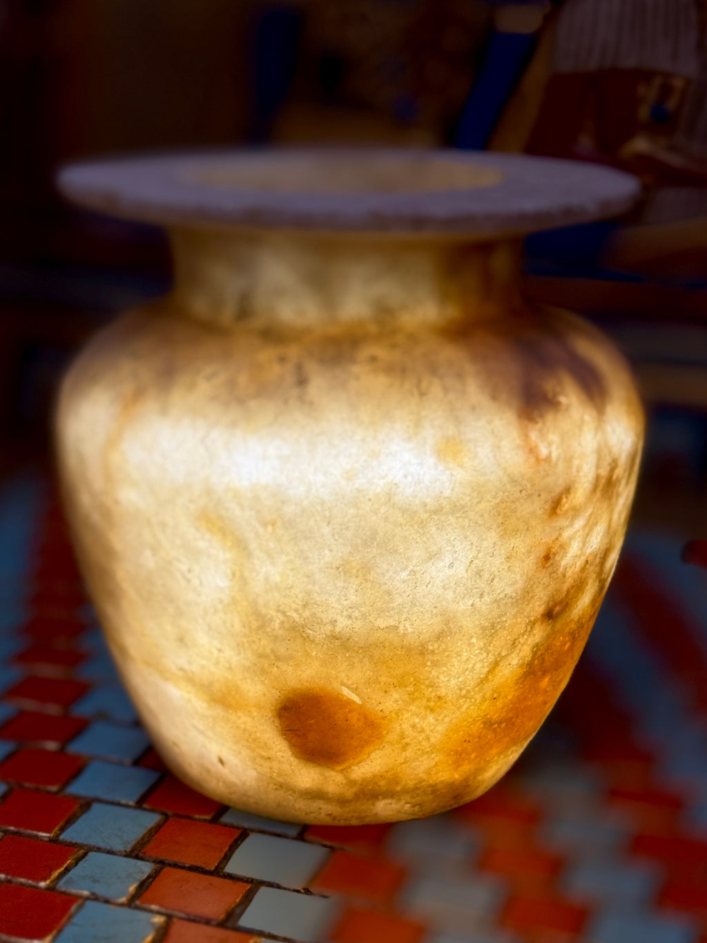 Small golden-cream alabaster vase with a rounded body, short neck and broad flared rim — additional view 2.