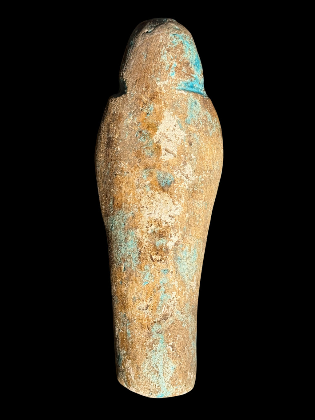 Rear view of the stone shabti showing its rounded headdress and tapered body with mottled turquoise, cream and sandy brown colouring.