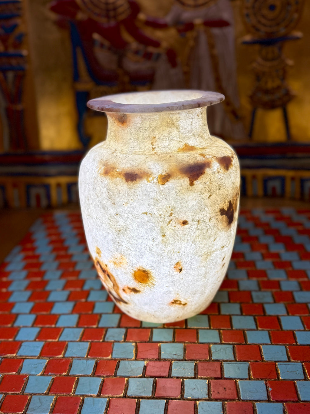 Small cream alabaster vase with warm brown markings, rounded shoulders and a flared rim — full view.