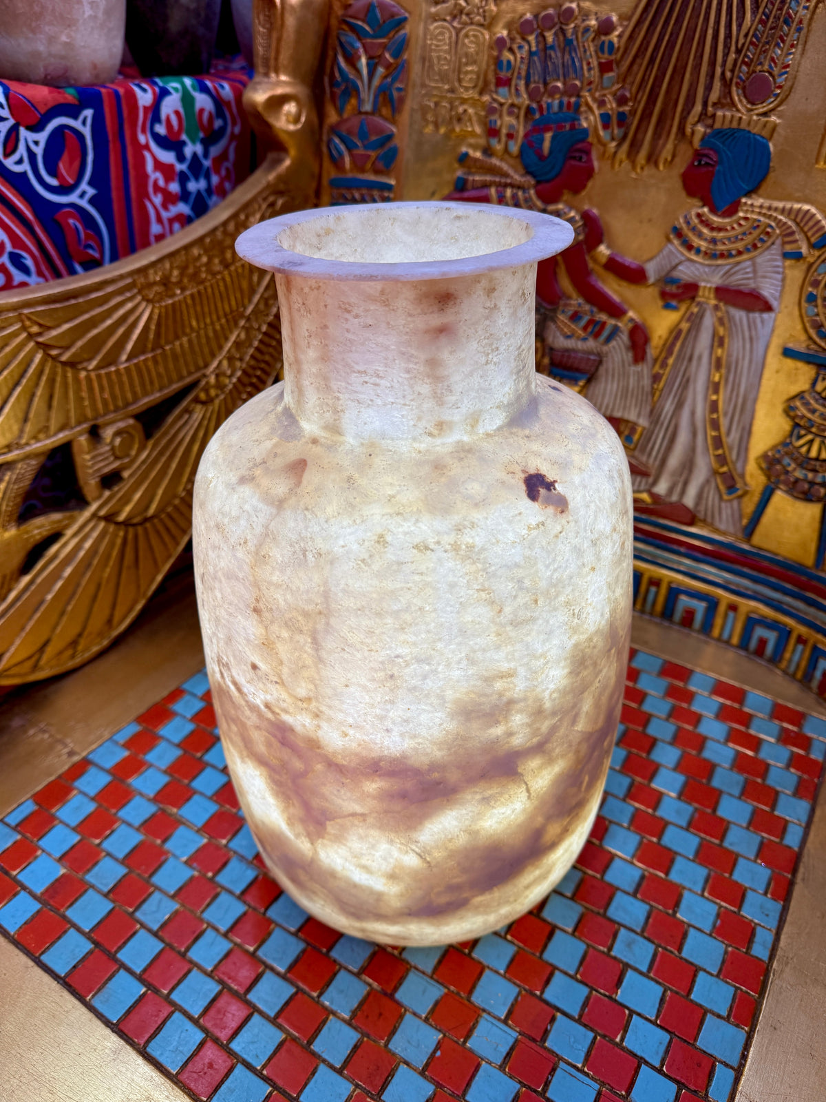 Tall alabaster vase with rounded shoulders, a flared rim and bold rust-brown markings on cream stone — additional view 3.