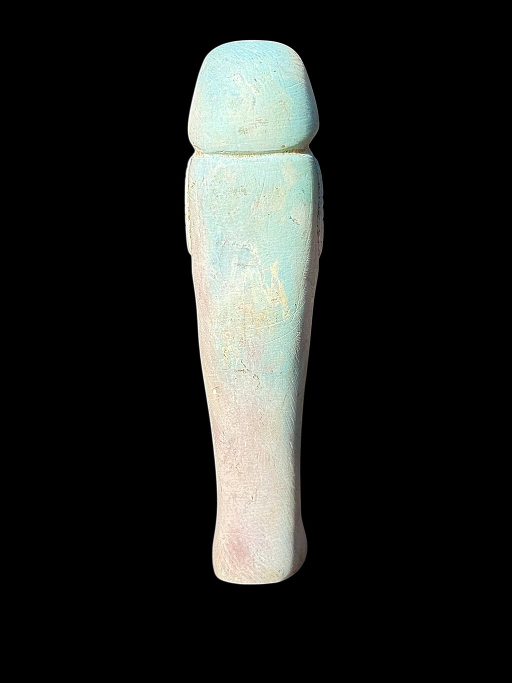 Back view of the shabti figurine showing a rounded headdress and plain tapered body with pale turquoise and cream surface texture.