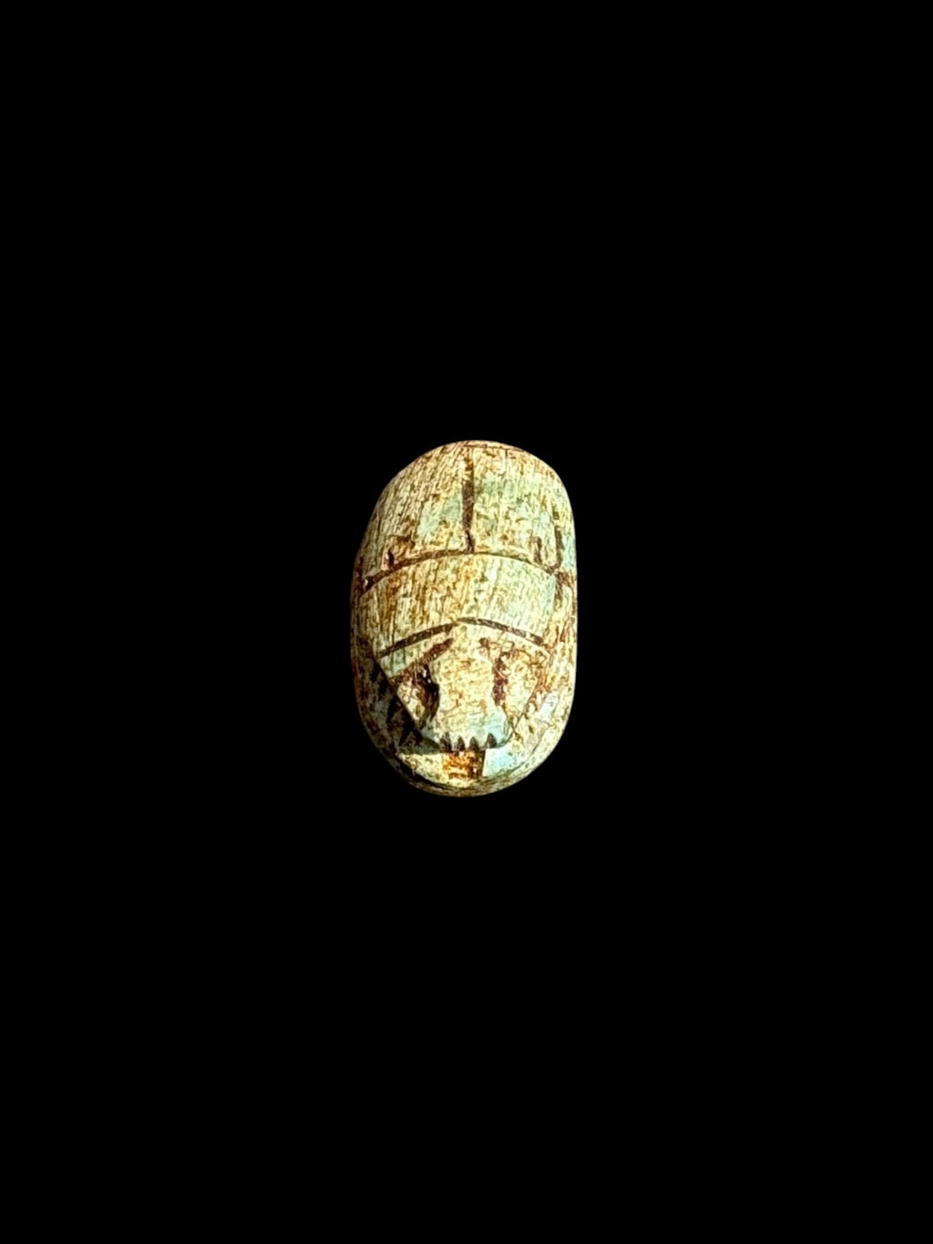 Top view of Egyptian scarab SC-051, showing cream tones with muted green accents.