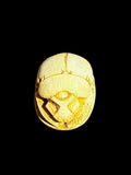Top view of Egyptian scarab SC-099, showing warm cream and golden tones.