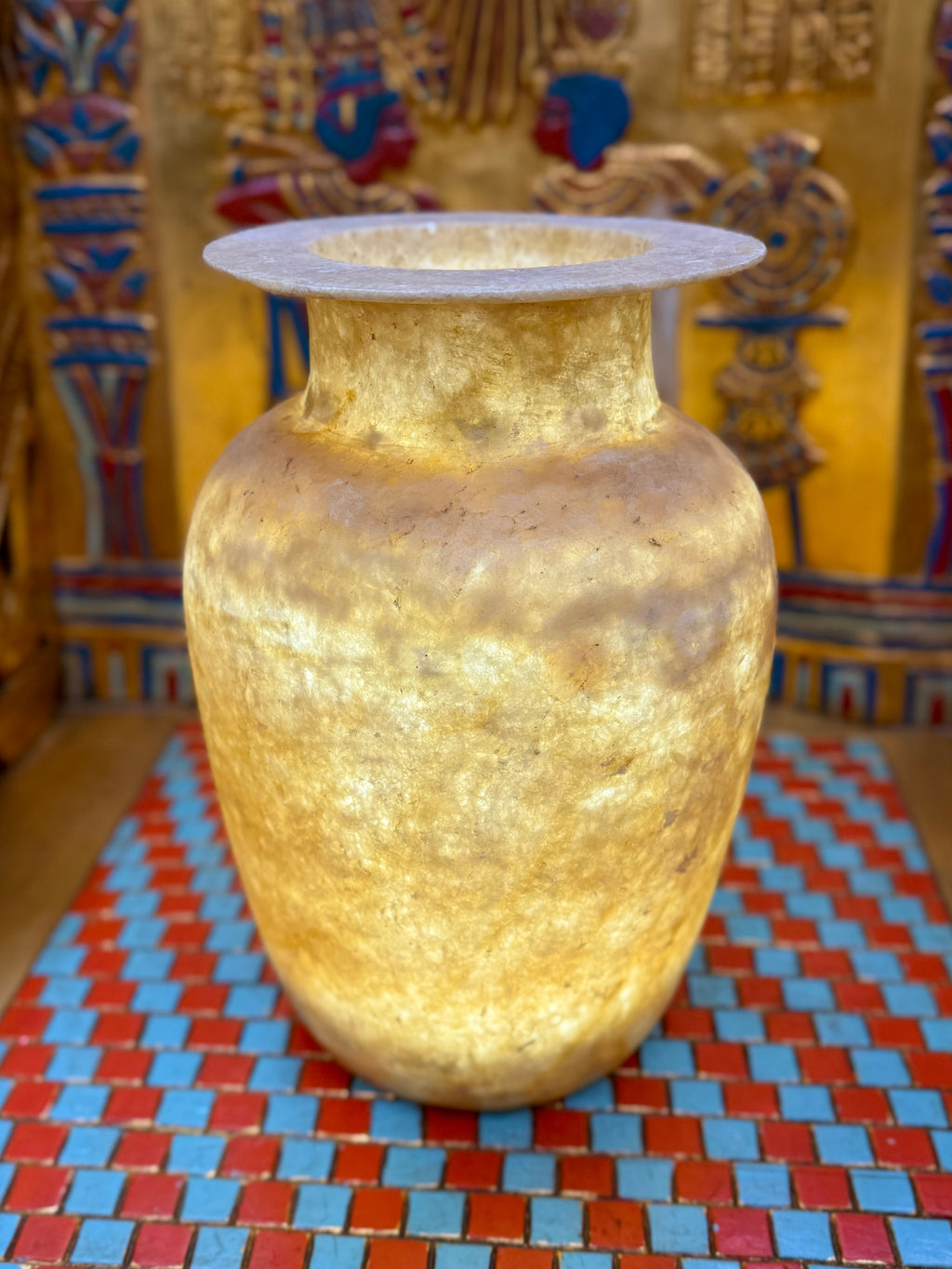 Tall alabaster vase with honey and smoky brown layers, rounded shoulders and a broad flared rim — full view.