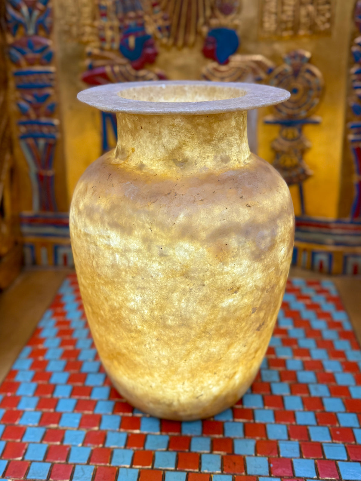 Tall alabaster vase with honey and smoky brown layers, rounded shoulders and a broad flared rim — full view.