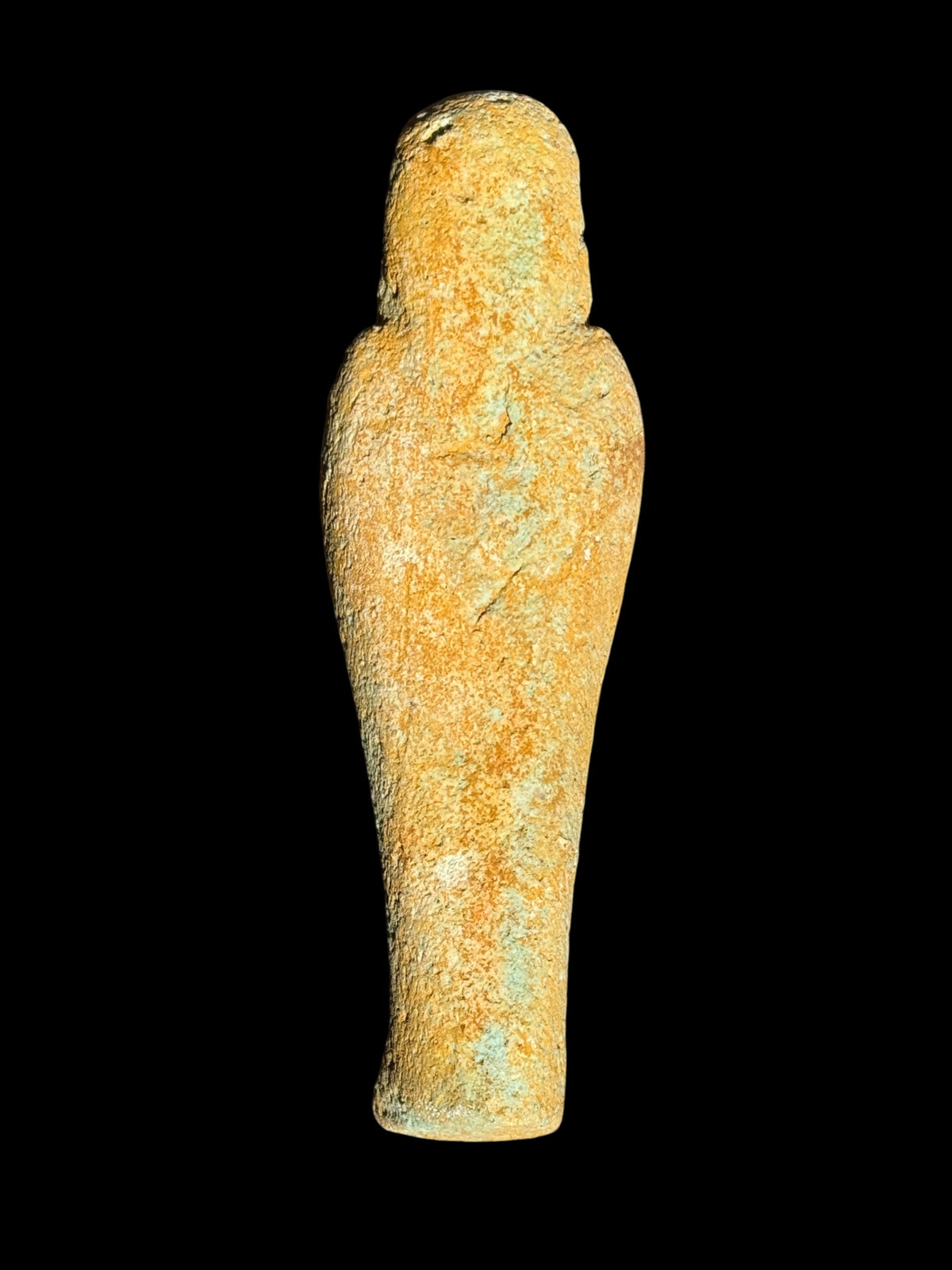 Back view of the Egyptian stone figurine with winged Isis showing a rounded head, broad shoulders and a tapered body with mottled ochre and pale blue-green colouring.