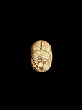 Top view of Egyptian scarab SC-067, showing warm cream and ochre tones with dark outlines.