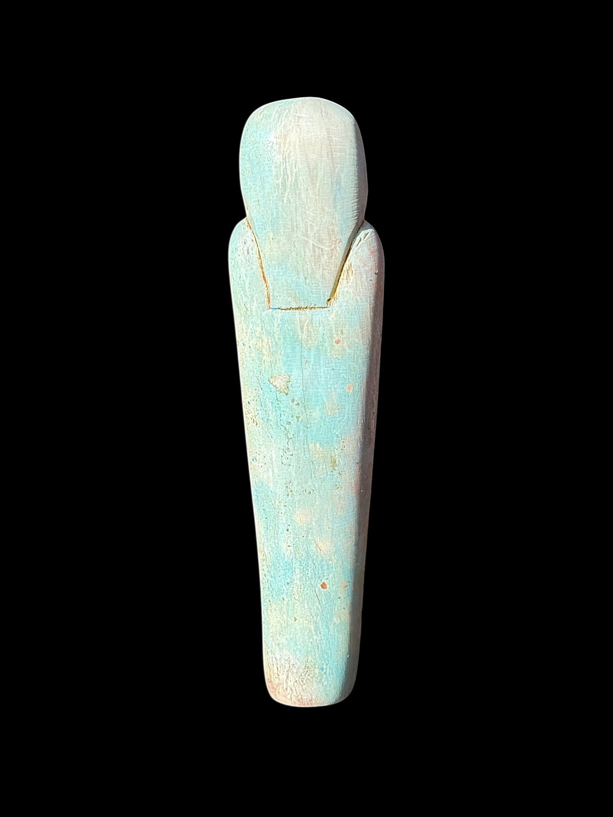 Back view of the shabti figurine showing an outlined headdress and a largely plain, tapered body with mottled turquoise, cream and tan colouring.