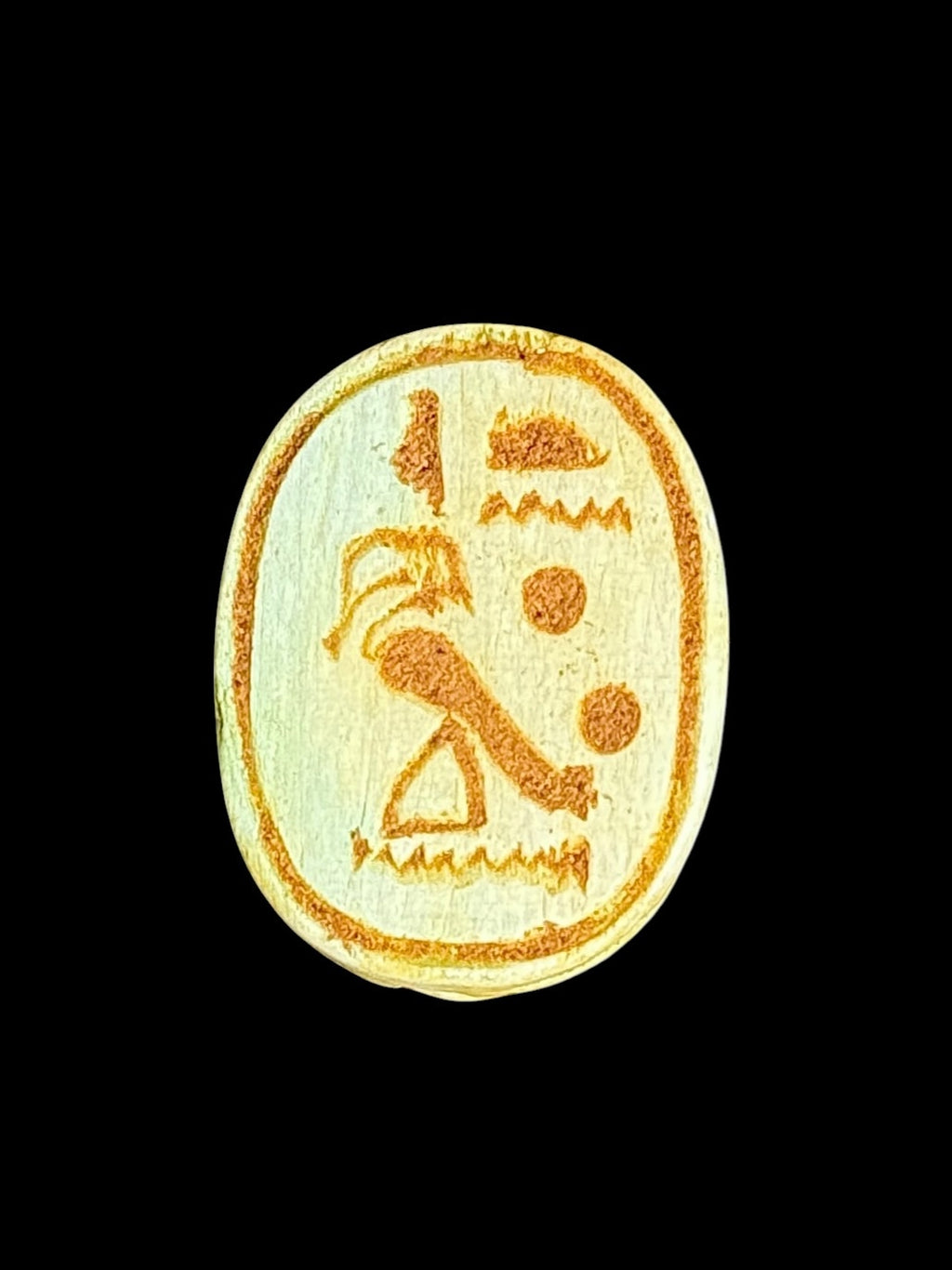 Underside of Egyptian scarab SC-100, showing pale underside with ochre motifs inside an oval border.