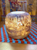 Low rounded alabaster vase with cascading honey-coloured patterns, smoky brown bands and an open rim — full view.