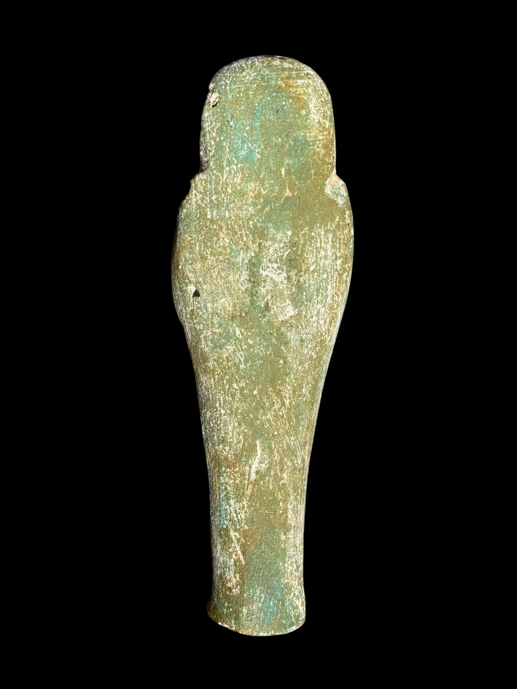 Back view of the shabti figurine showing a rounded head, largely plain reverse and mottled green, cream and tan surface.