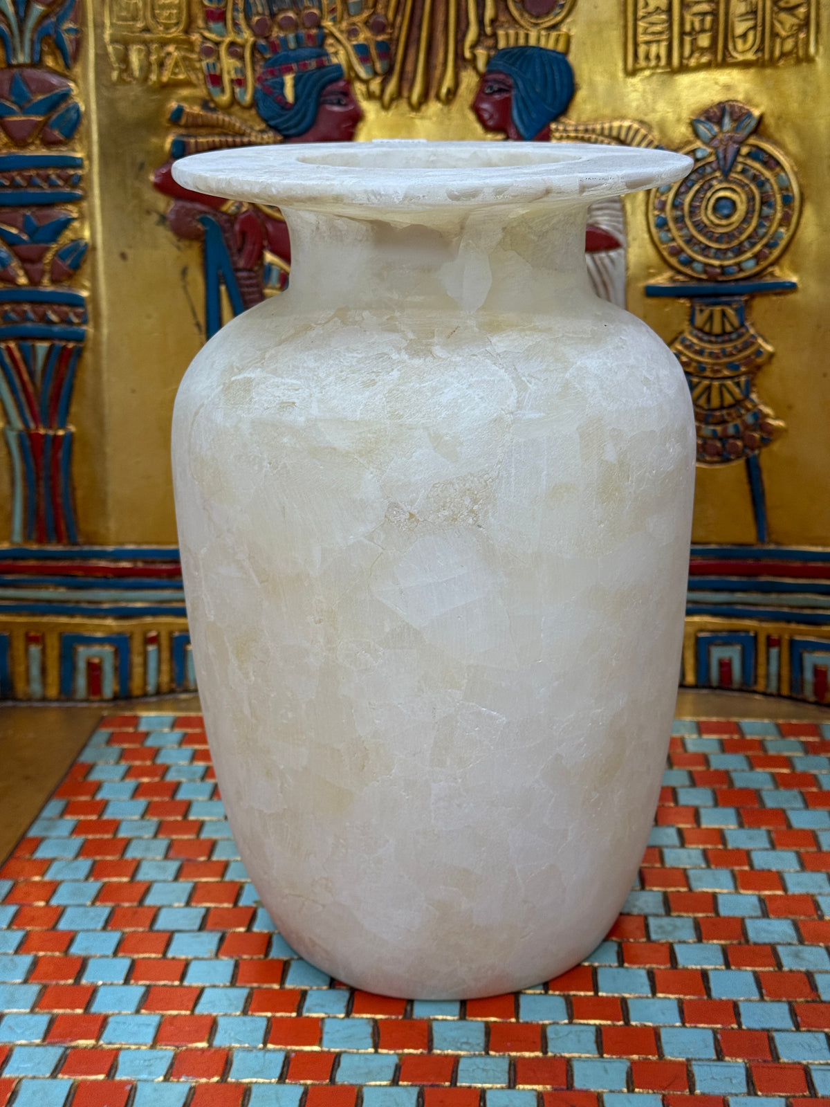 Tall ivory and cream alabaster vase with mosaic-like patterns and a broad flared rim — unlit full view.