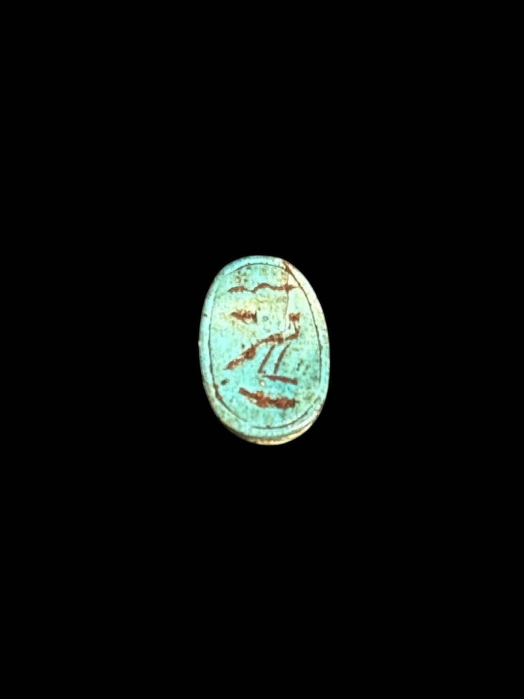 Underside of Egyptian scarab SC-058, showing turquoise underside with contrasting incised markings.