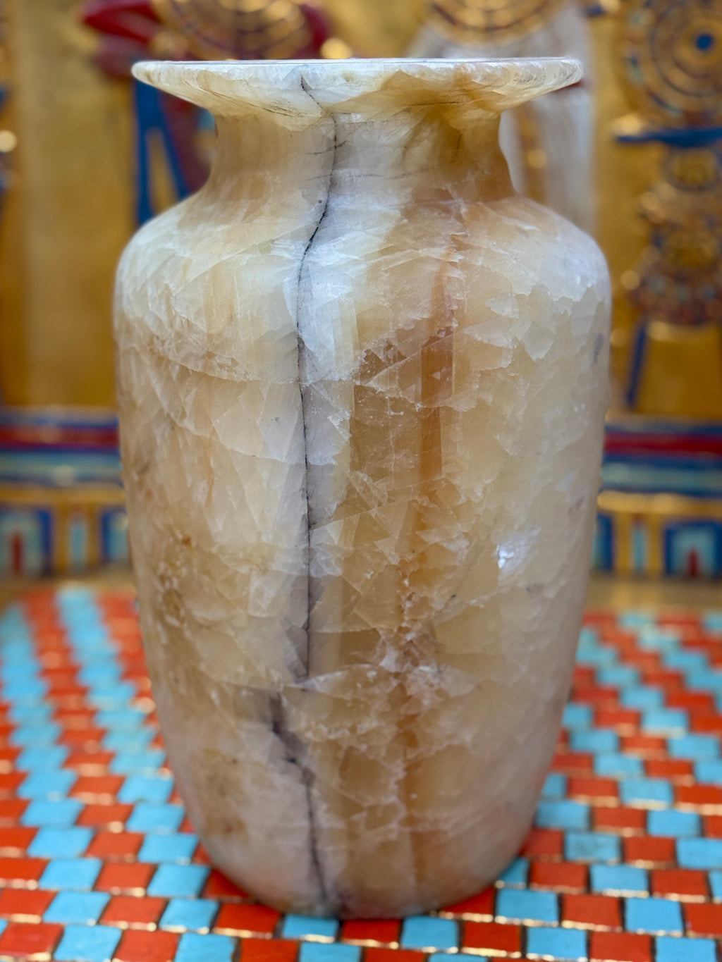 Tall cream and amber-banded alabaster vase with a slender smoky line and flared rim — unlit full view.