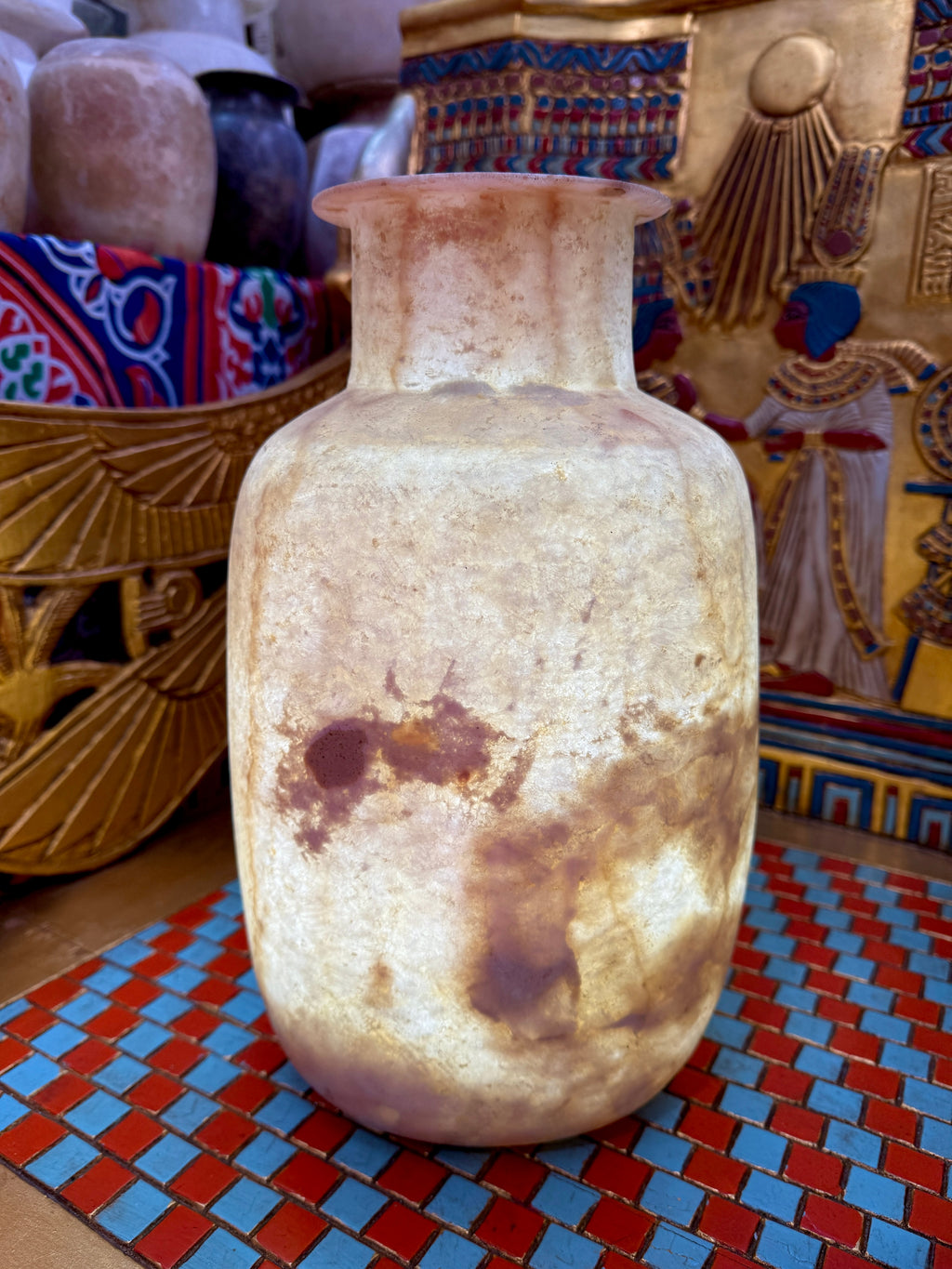 Tall alabaster vase with rounded shoulders, a flared rim and bold rust-brown markings on cream stone — additional view 2.