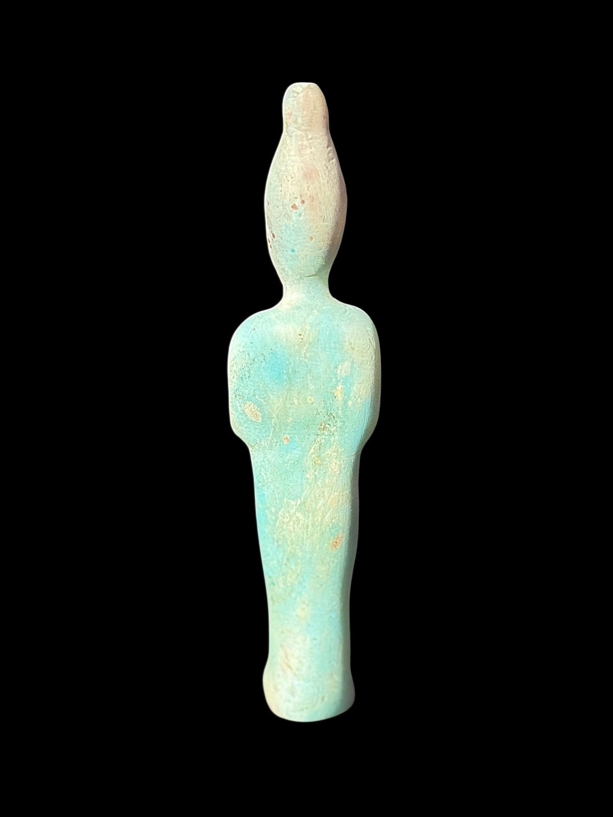 Back view of the shabti showing its tall rounded crown, narrow body and plain mottled turquoise-green and cream surface.