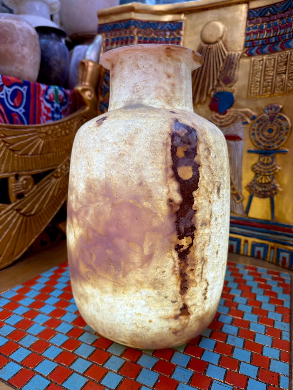 Tall alabaster vase with rounded shoulders, a flared rim and bold rust-brown markings on cream stone — additional view 1.