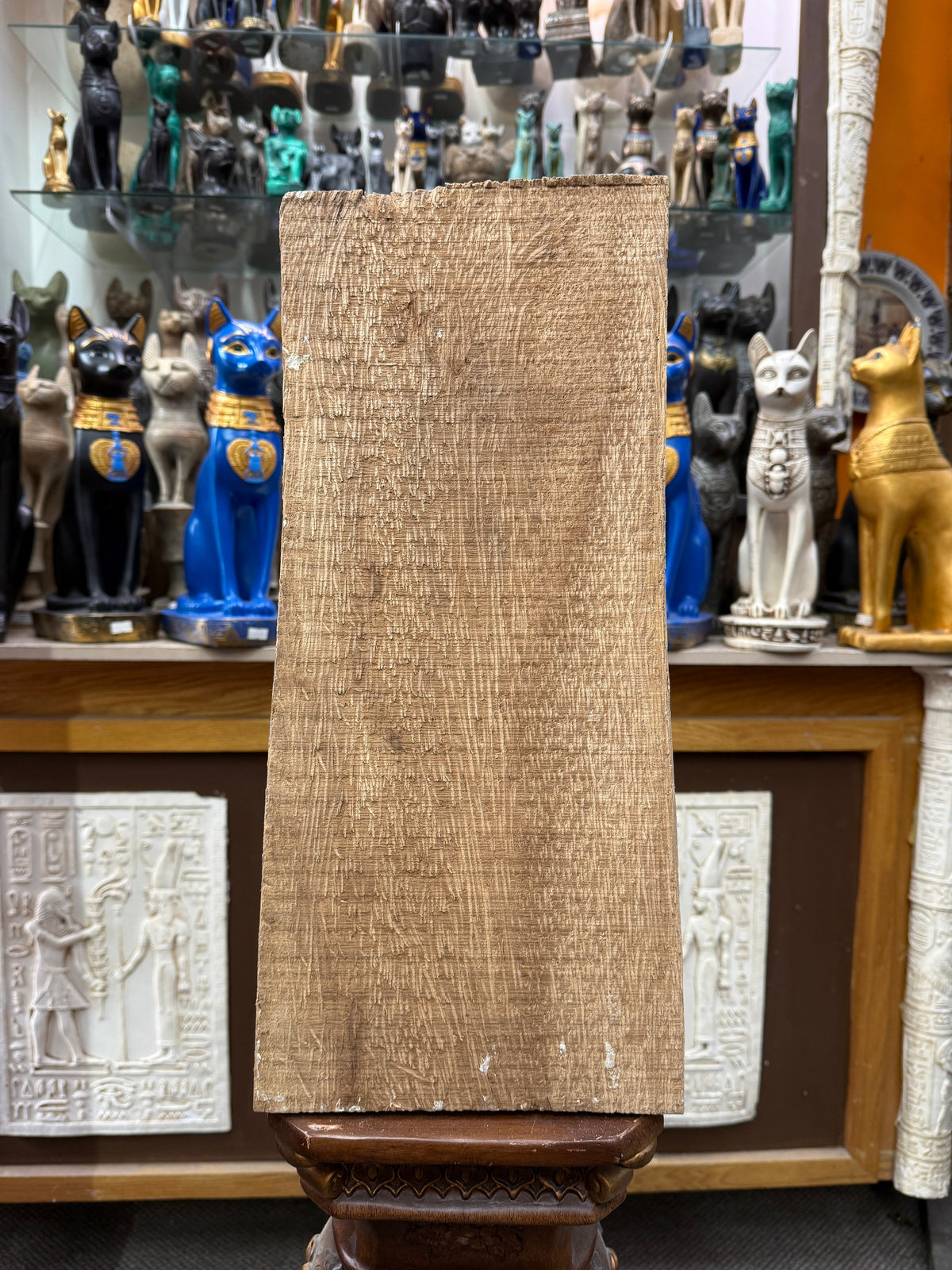 Back of the second Book of the Dead wood plaque, showing its unpainted wooden surface.