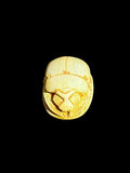 Top view of Egyptian scarab SC-104, showing warm cream tones and golden accents.