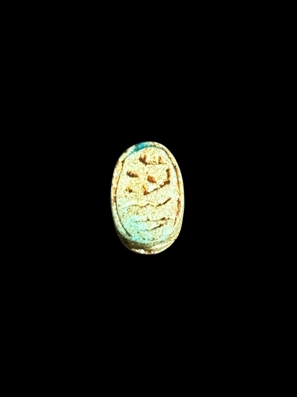 Underside of Egyptian scarab SC-067, showing pale turquoise underside with incised markings.