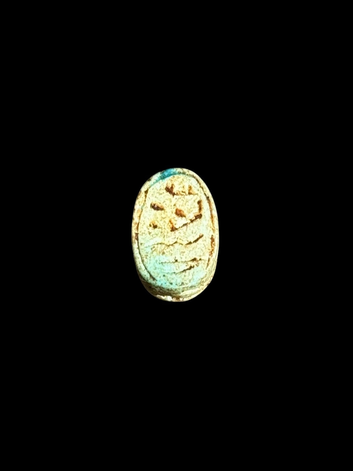 Underside of Egyptian scarab SC-067, showing pale turquoise underside with incised markings.