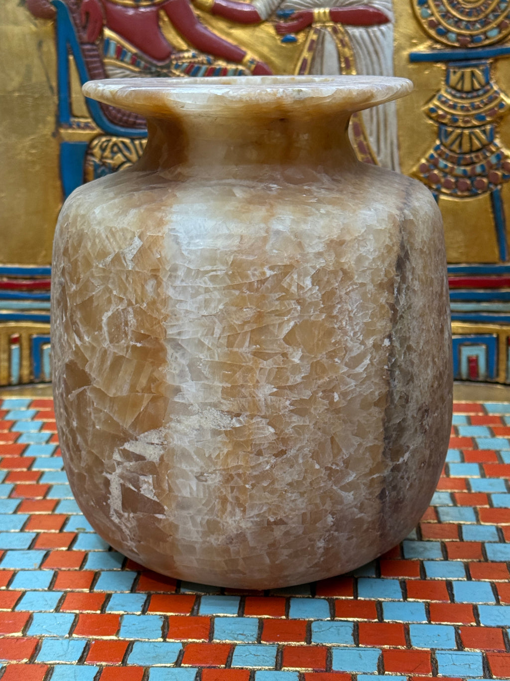 Broad alabaster vase with caramel and cream bands, rounded shoulders and a wide flared rim — unlit full view.