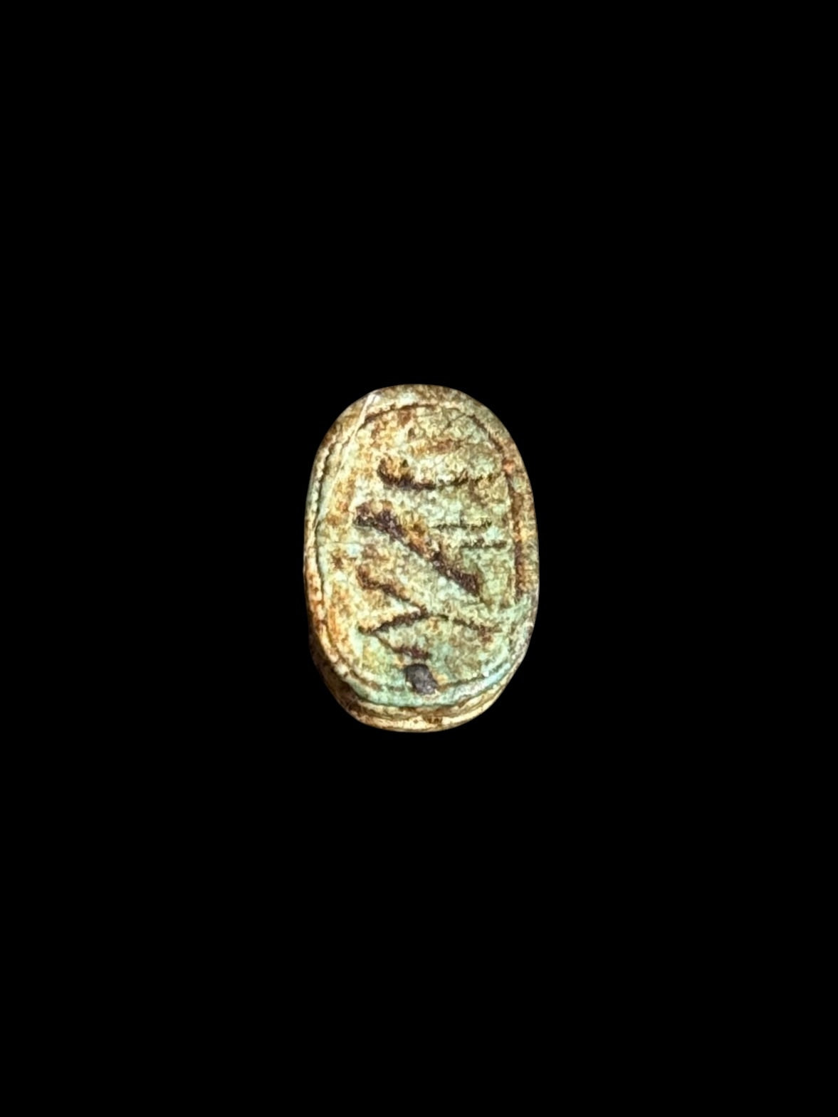 Underside of Egyptian scarab SC-065, showing muted green underside with darker incised markings.