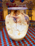 Tall cream alabaster vase with chestnut-brown patches, fine veining and a flared rim — full view.